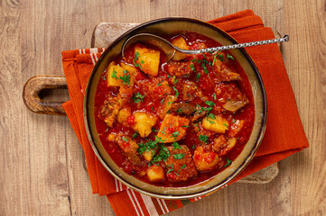 Potatoes with meat, stewed in tomato sauce, with spices and herbs, homemade, no people,