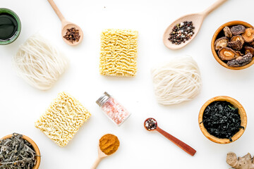 Chinese and Japanese food cooking with ginger, spices and noodles on white background top view geometric pattern