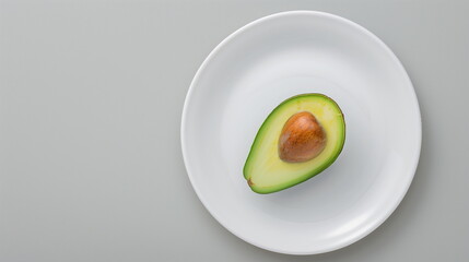 Fresh Half Avocado With Visible Seed on White Plate Placed on Grey Surface Minimalistic Food Photography Nutrition Concept Healthy Organic Diet