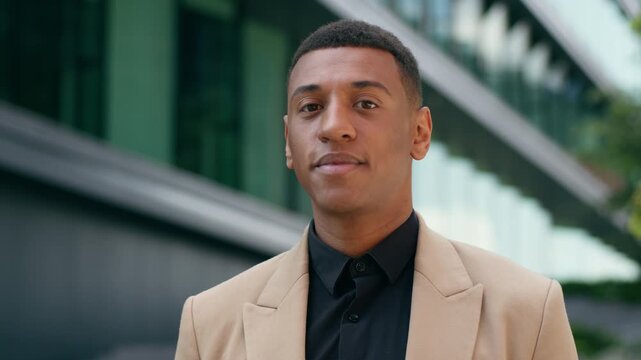 Portrait thinking pensive African American male entrepreneur look away ponder looking at camera employer guy business man realtor real estate trader in city urban businessman office building smiling