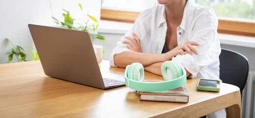 Young attractive woman in headphones learning online at home. Distance education concept	
