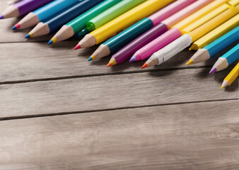 Colored pencils on a wooden table. Back to school concept. Stationery composition.