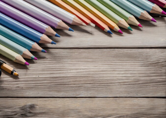 Colored pencils on a wooden table. Back to school concept. Stationery composition.