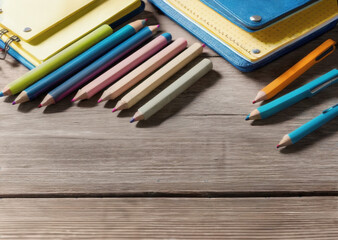 Colored pencils on a wooden table. Back to school concept. Stationery composition.