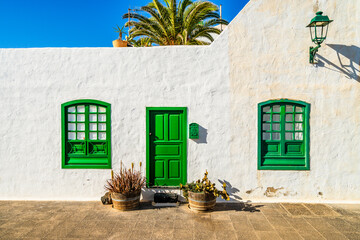 Picturesque whitewashed architecture with green elements in Costa Teguise, Lanzarote, Canary Islands