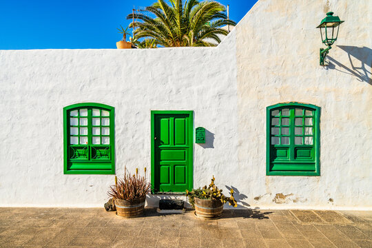 Picturesque whitewashed architecture with green elements in Costa Teguise, Lanzarote, Canary Islands