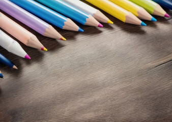 Colored pencils on a wooden table. Back to school concept. Stationery composition.