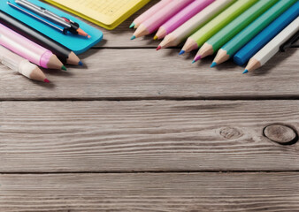 Colored pencils on a wooden table. Back to school concept. Stationery composition.