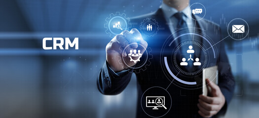 CRM Customer relationship management concept. Businessman pressing button on screen.