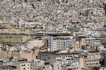 View of the overbuilding city of Athens Greece. Urbanization concept. Many light buildings stand close each to other. Dense development of city, population density
