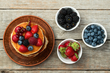 Stack of homemade american pancakes with berries . Top view