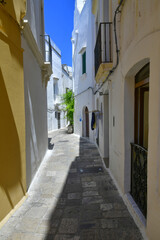 A narrow street in the historic center of Gallipoli, a tourist town in Puglia in Italy.