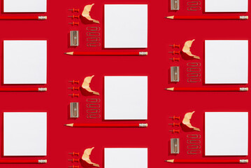 Pattern of empty white paper sheet for notices with red pencil, pins and clips on a red background....