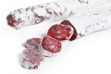 Fuet.Dry cured fuet sausage, isolated on white background. Copy space