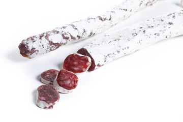 Fuet.Dry cured fuet sausage, isolated on white background. Copy space
