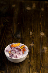 natural yogurt in a white bowl with fruits