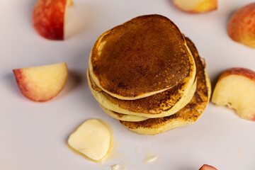 milk pancakes with butter and sliced peach slices