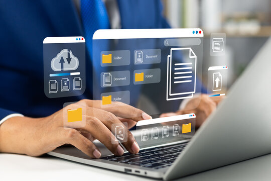 Businessman using computer laptop and dashboard for data management with computer showcasing a cloud-based documentation system for efficient digital file storage,online documentation technology