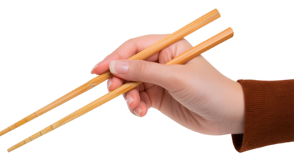 A hand holding a pair of wooden chopsticks, perfect for presentations related to Asian cuisine and dining culture.