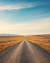 Fototapeta premium Panoramic view of a deserted gravel road disappearing into the horizon, expansive arid plains, soft blue sky with wispy clouds, warm golden light, tranquil and endless scenery