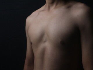 Closeup of body asian young man black background, health care and medical concept