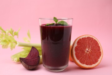 Tasty beetroot smoothie and fresh products on pink table