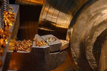 Close up scene the lathe machine finish cut the brass material parts by lathe tools.