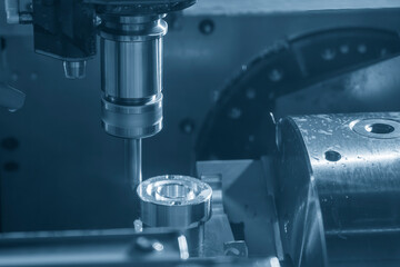 The 4-axis CNC milling machine  cutting the automotive part with solid flat end mill  tools.