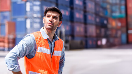 Young confident Caucasian man engineer check for control loading containers box from Cargo freight ship for import and export, transport	
