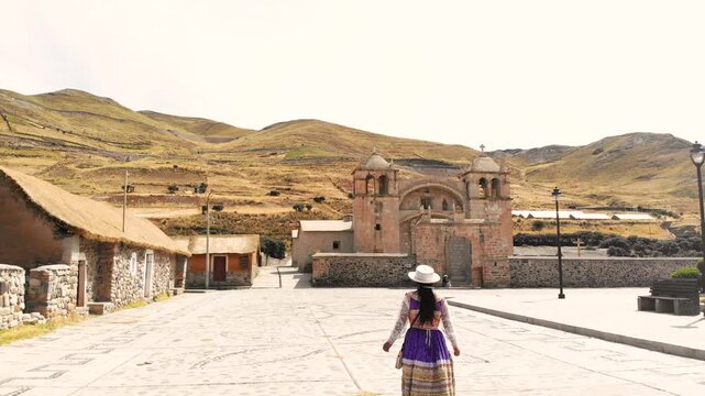 Woman with typical costume from the Colca Valley walking in traditional town in Arequipa Peru