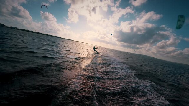 Young man kite surfing. Extreme kite boarding in slow motion. Summer fun action sports. Happiness in nature