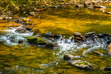 Paint Creek gurgles over rocks in a slow moving stream in Greene County Tennessee