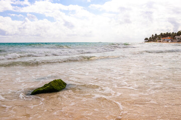 Stones rocks boulders in turquoise blue water Caribbean beach Mexico.