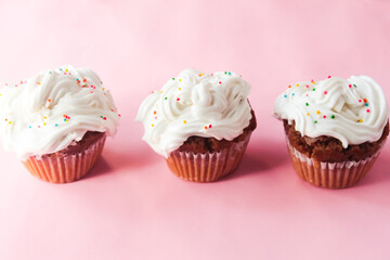 several cupcakes on a pink background