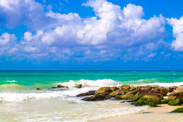 Stones rocks boulders in turquoise blue water Caribbean beach Mexico.