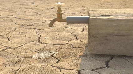 Drought and Water Scarcity. a leaking faucet on dry, cracked soil, symbolizing drought and urgent water scarcity issues. agricultural problems, climate change
