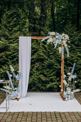 Elegant outdoor wedding arch with floral decorations for a romantic garden ceremony