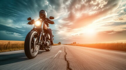 Naklejka premium A biker in a sleek helmet riding a motorcycle along a scenic road