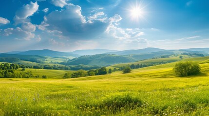 Obraz premium A picturesque summer landscape with rolling hills, green meadows, and a bright blue sky