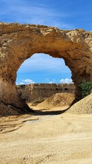 Natural Arch in Ghajn Abdul, Gozo, Malta, Limestone Rock Formation under Blue Sky