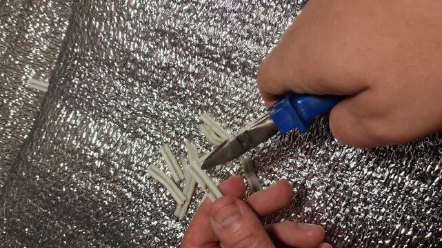 man cutting wires with nippers. electrician's work. nippers and wires. technology. work in production. wiring.