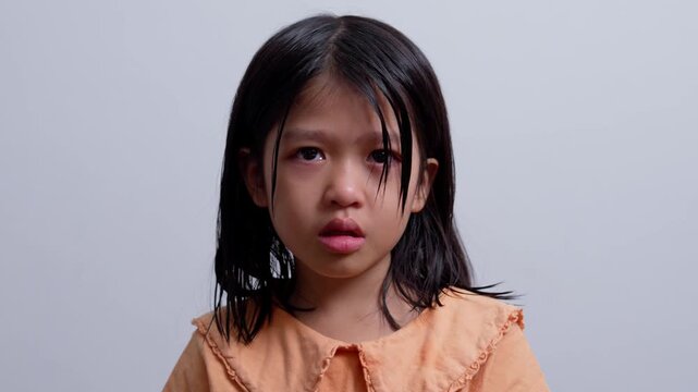 A Litter Asian girl sitting in room conner and crying after Punished by the blackout.