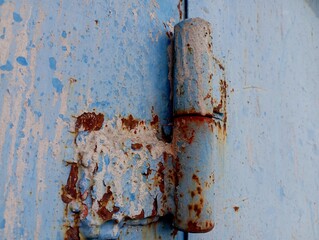 Old blue curtain on metal door. texture of old steel curtains with traces and stains and rust. Industrial backgrounds and textures.