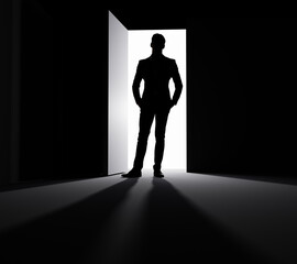 A man stands in the doorway of a large ajar door in the rays of light.