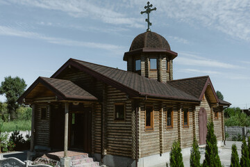 Orthodox village church made of logs.СSiSinBlue Blue clear sky.