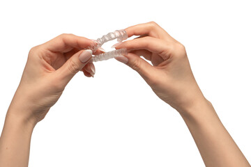 Transparent mouth guard in a woman's hand isolated on white background.