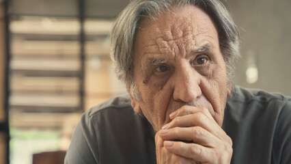 Sad and thoughtful old man