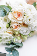 Exquisite wedding bouquet on a white table, white roses.