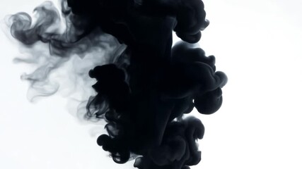 Black ink is creating mesmerizing patterns while dissolving in a clear liquid, resembling a dance of smoke and shadows. The abstract shapes evoke a sense of mystery and intrigue