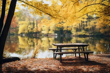 Obraz premium A serene picnic area by a lake surrounded by autumn foliage.